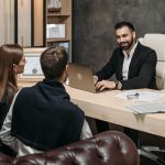 A professional meeting with a lawyer consulting clients in an upscale office environment.